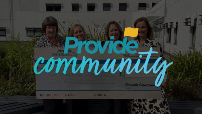 The Provide CIC logo with four women holding a large cheque in the background.